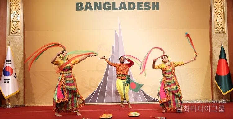 A Bangladeshi dance troupe presents a folk dance to the audience.