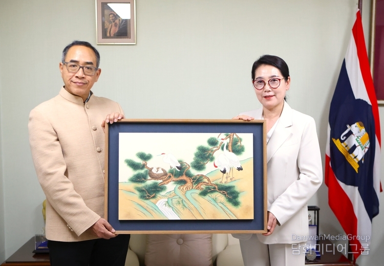 Cultural Editor Lee Mi-hyung (right) of Diplomacy Journal who is also professor of the Department of Cultural Content, the Institute for Adult & Continuing Education of Myongji University, presents a folk painting to Amb. Tanee Sangrat of Thailand as a gift.