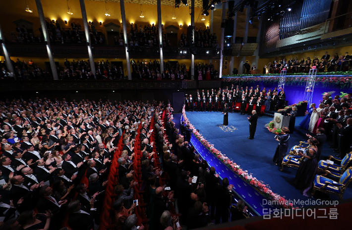 Han Kang is applauded after receiving the Nobel Prize in Literature medal and certificate from Swedish King Carl Gustaf XVI during a ceremony at the Stockholm Concert Hall in Stockholm, Sweden, on Dec. 10, 2024.
